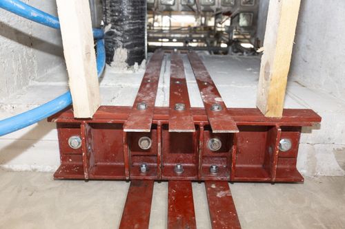 Steel brackets bolted to RC wall.