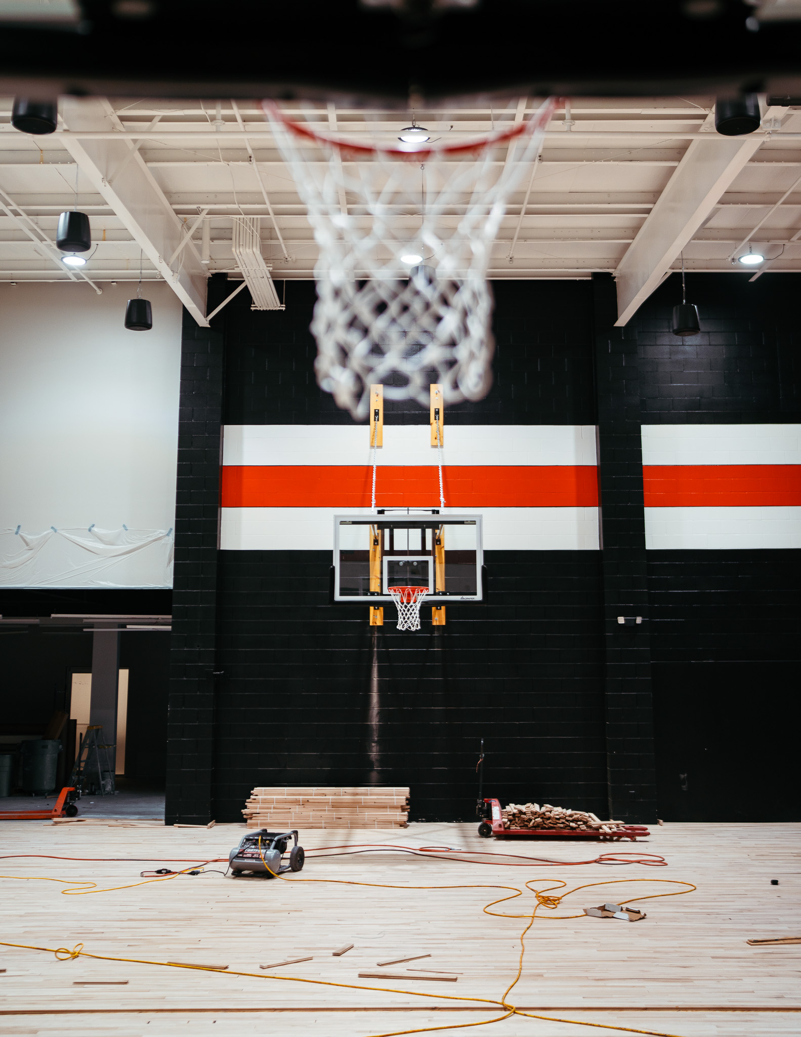 Hardwood basketball court installation at Forge Performance Lab by Modern Ozarks NWA