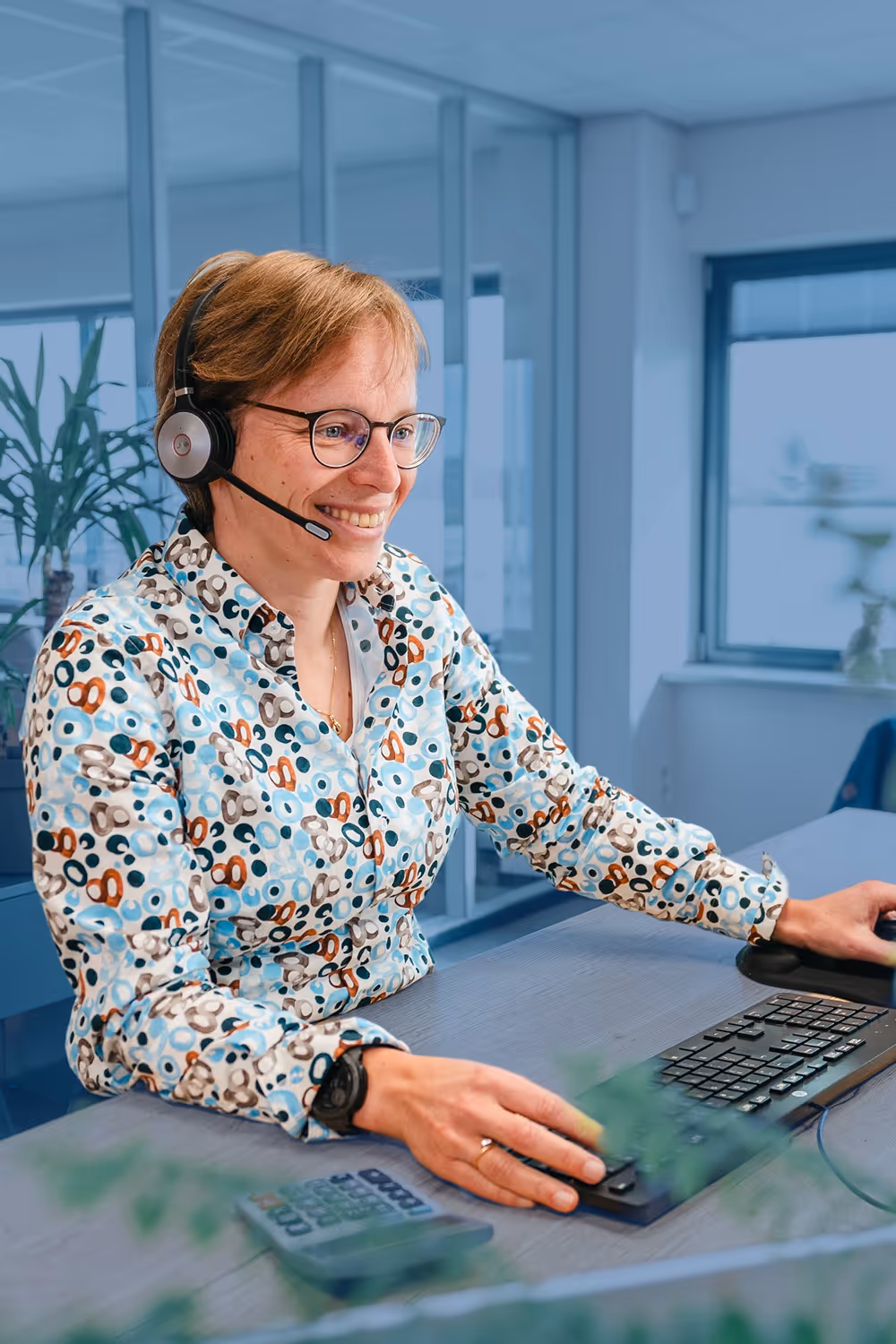 Werknemer van Nobel spreek een klant via de telefoon achter de computer