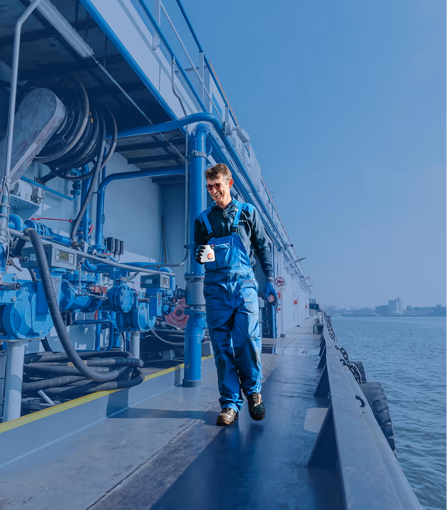 A Nobel bunkering services employee walks with a sample bottle