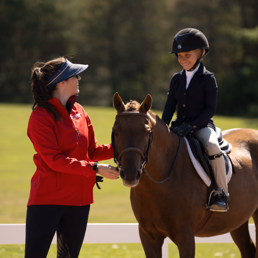 happy child during horse riding lesson