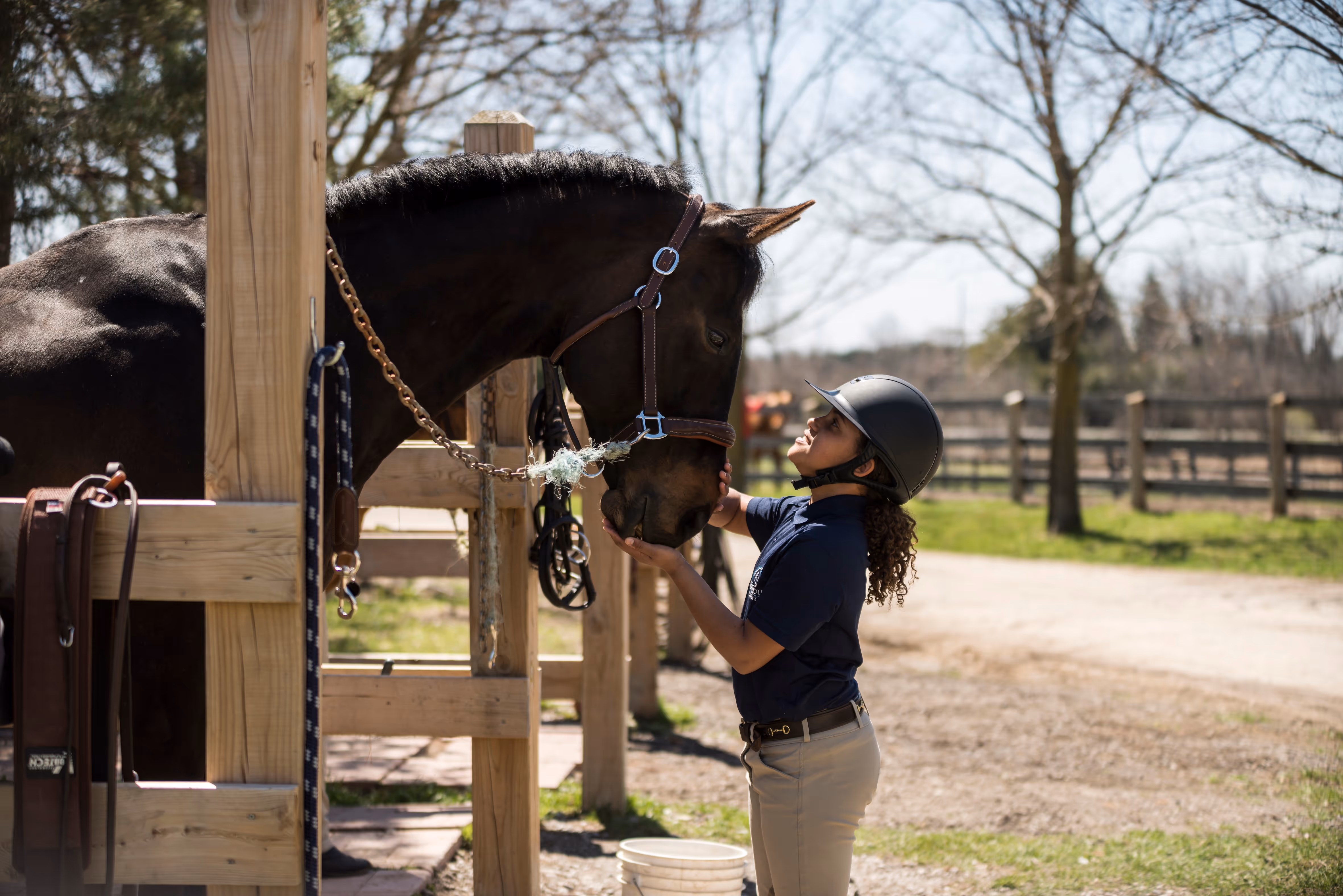 young rider giving their horse affection