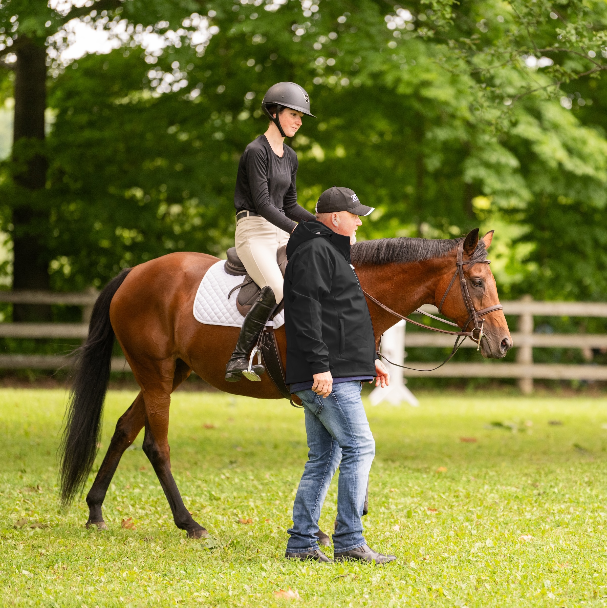 coach walking beside a rider