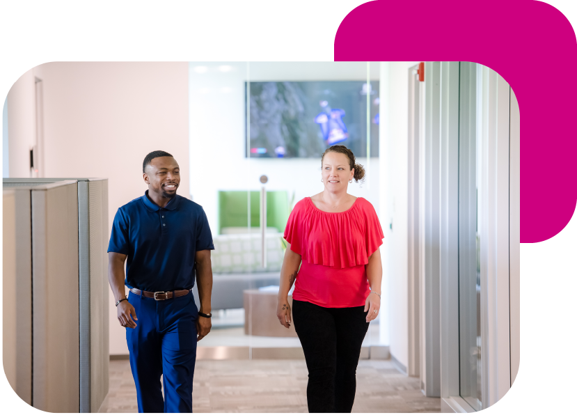 A CPA and a consultant walk the halls at their office. 