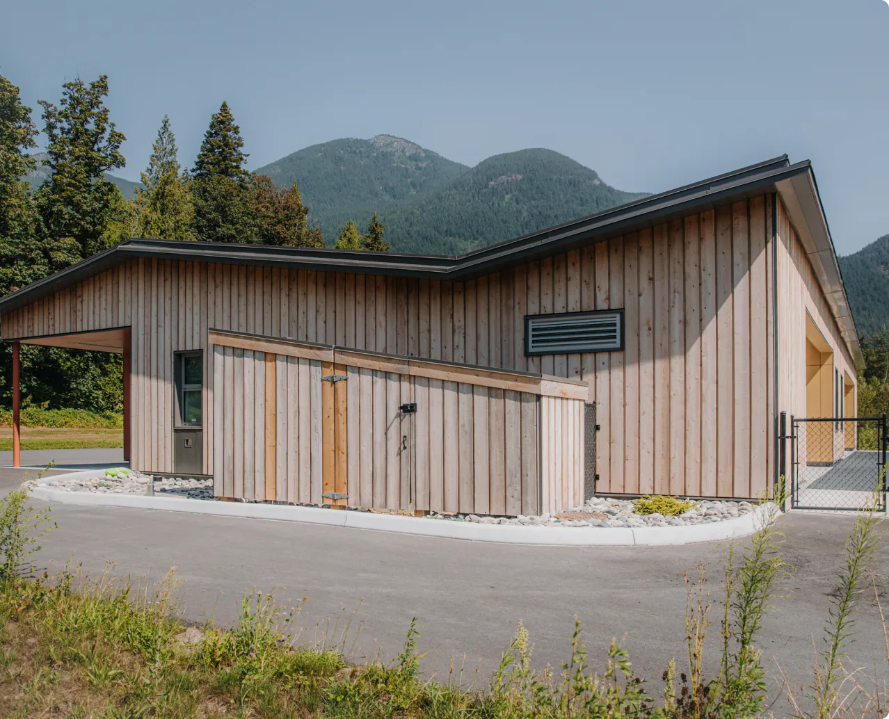 A wooden building with a metal fence around it.