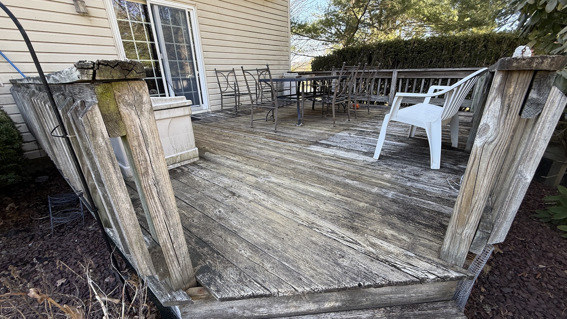 Weathered and damaged wood deck before replacement