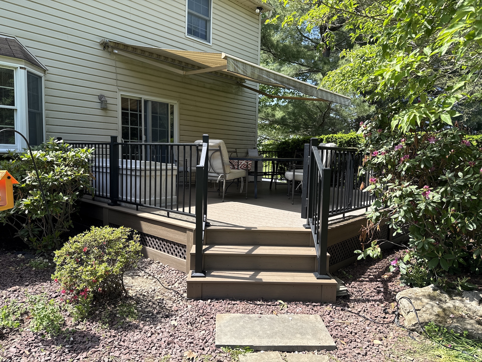 Newly completed composite deck with stairs and black railing