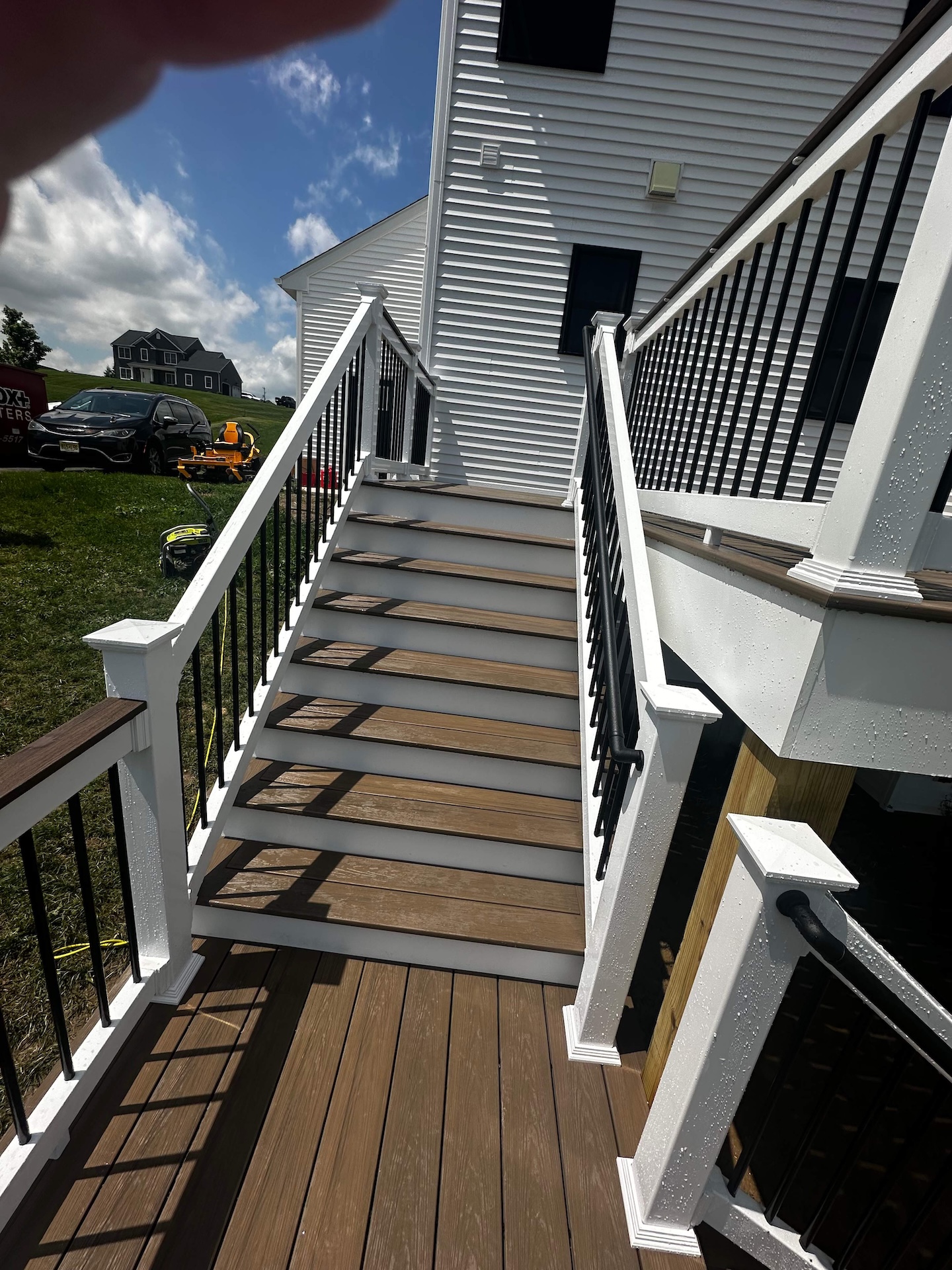 Close-up of stairs with Deckorators Sandbar decking and black railings