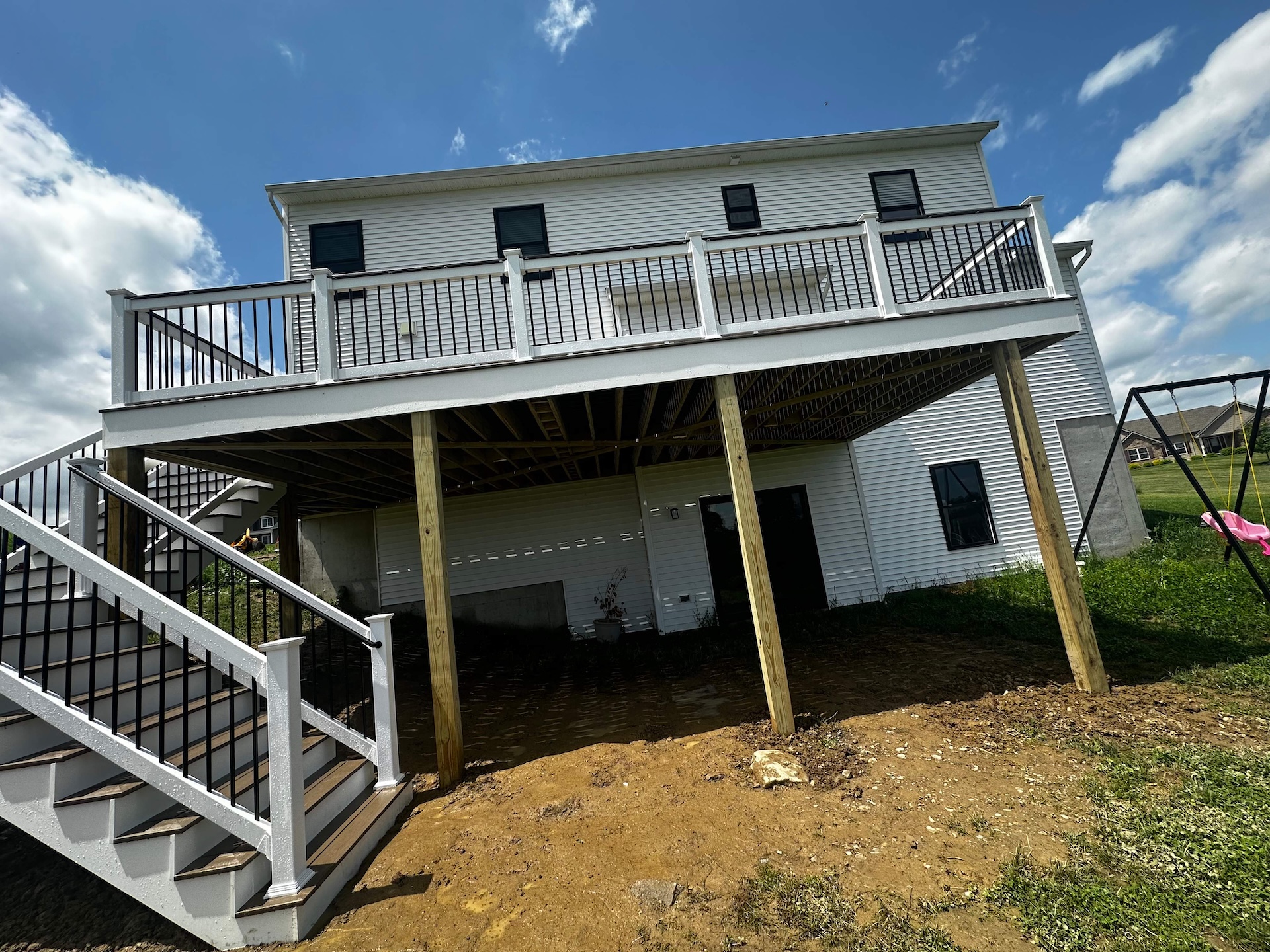 Rear elevation of 2nd floor deck with white and black railings
