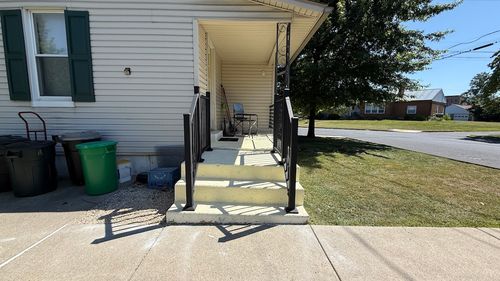 Black aluminum deck railing installed on concrete front porch steps at a residential home in Allentown, Pennsylvania