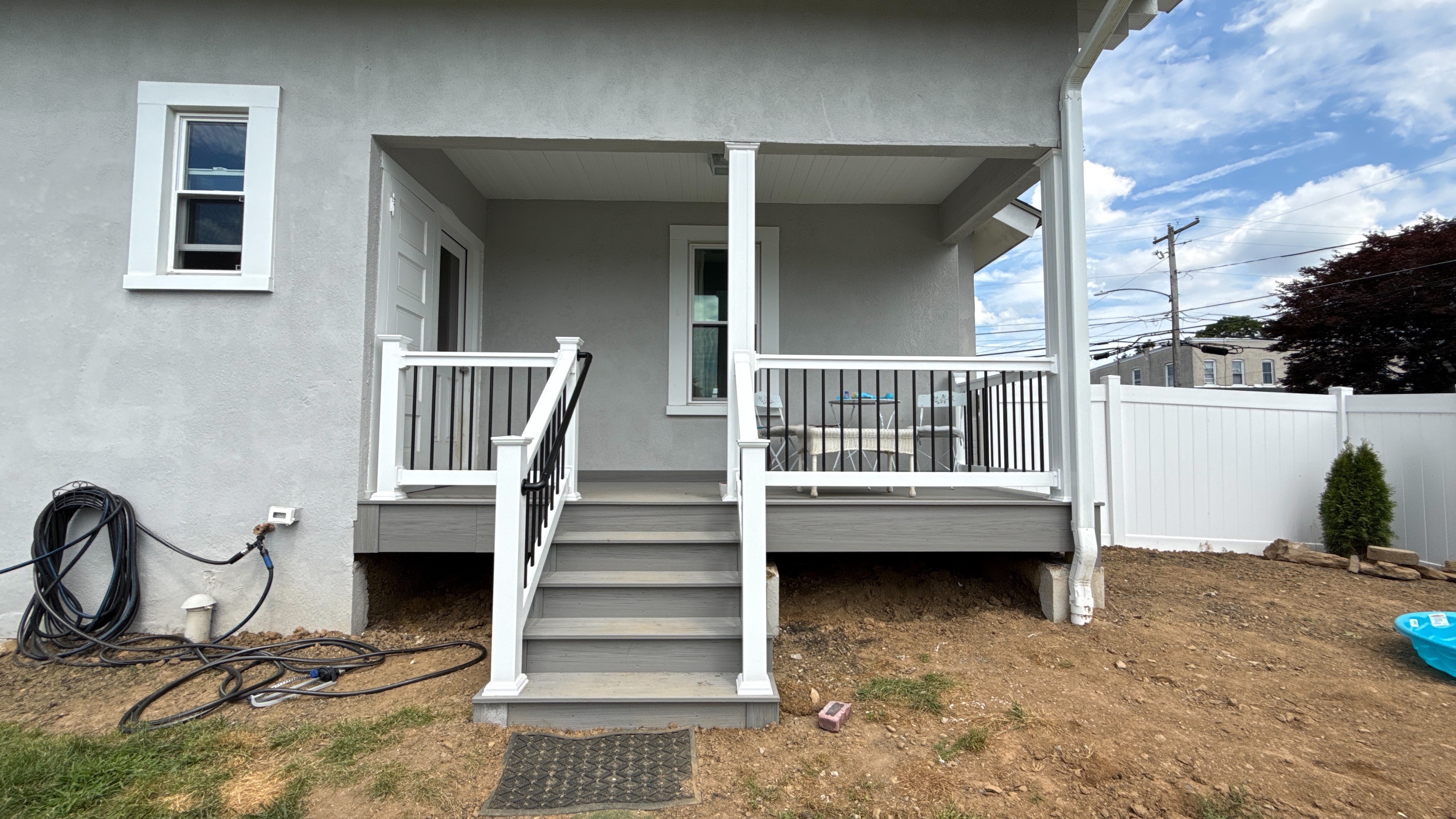 New Glacier-colored composite deck with white vinyl railing and black balusters, built by Upgryd in Allentown, PA.