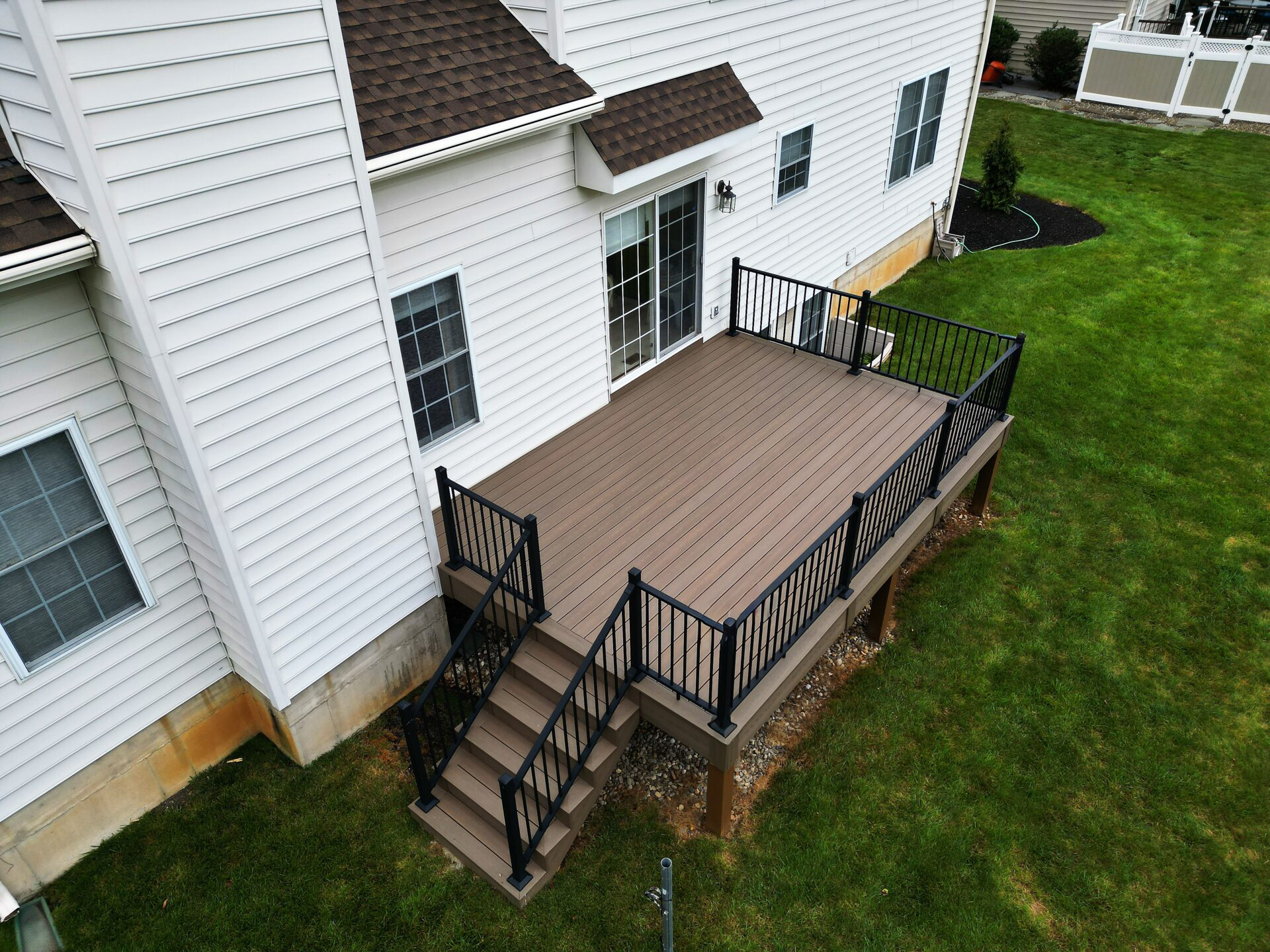 Deckorators Venture Sandbar decking and black aluminum railings in Bethlehem, PA.