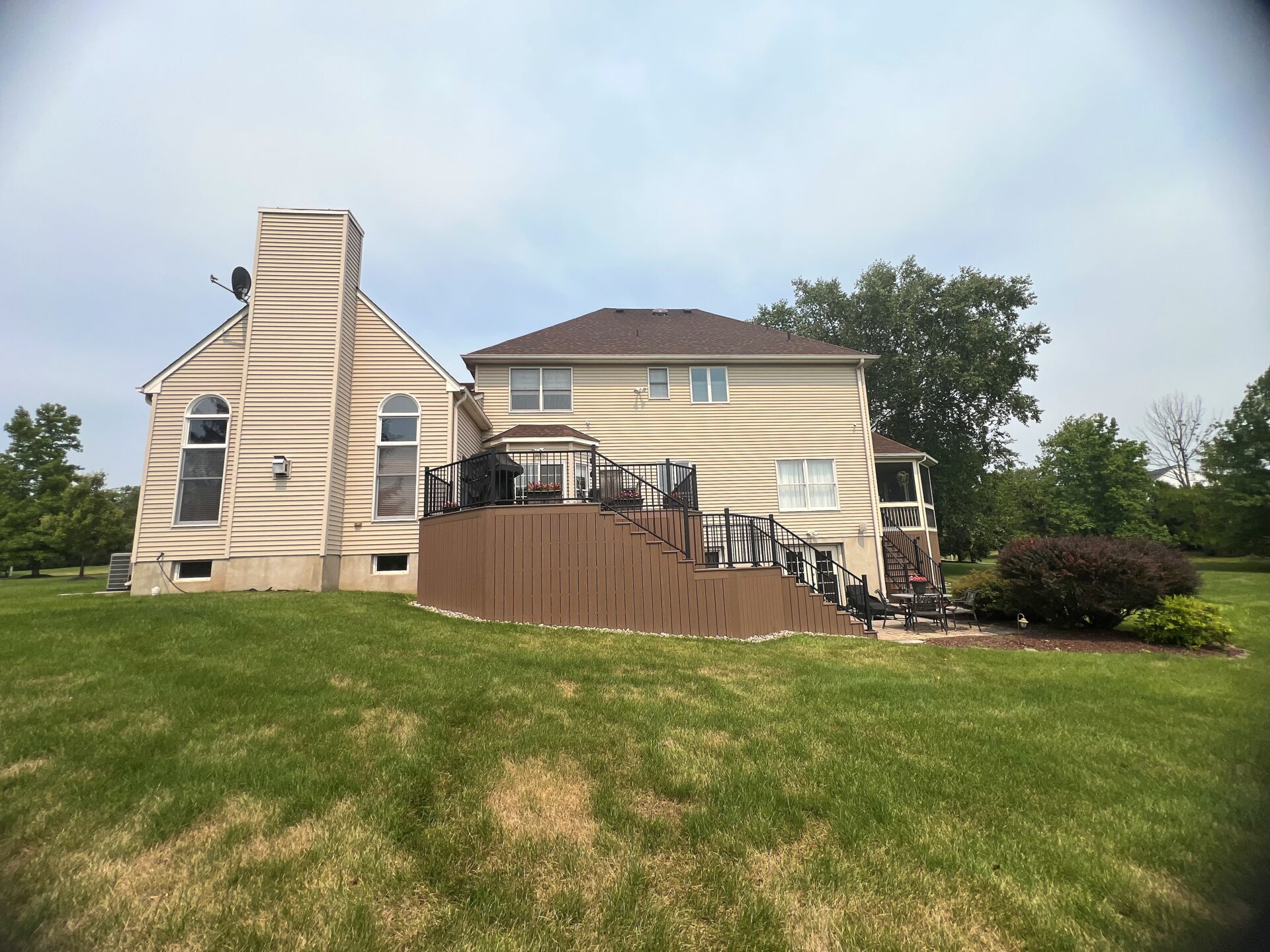 Resurfaced composite deck with Deckorators Summit Boulder decking and black aluminum railing in Ringoes, NJ.
