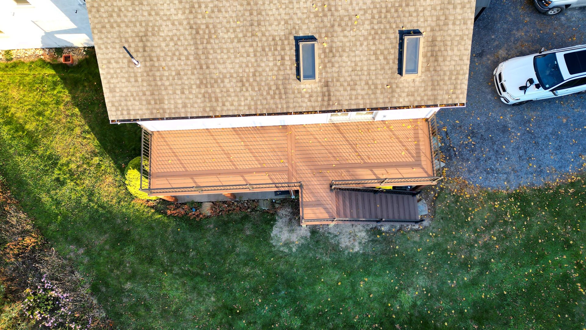 Overhead aerial view of a resurfaced 2nd-floor deck with Deckorators Summit Boulder decking and black aluminum railing in Slatington, PA.