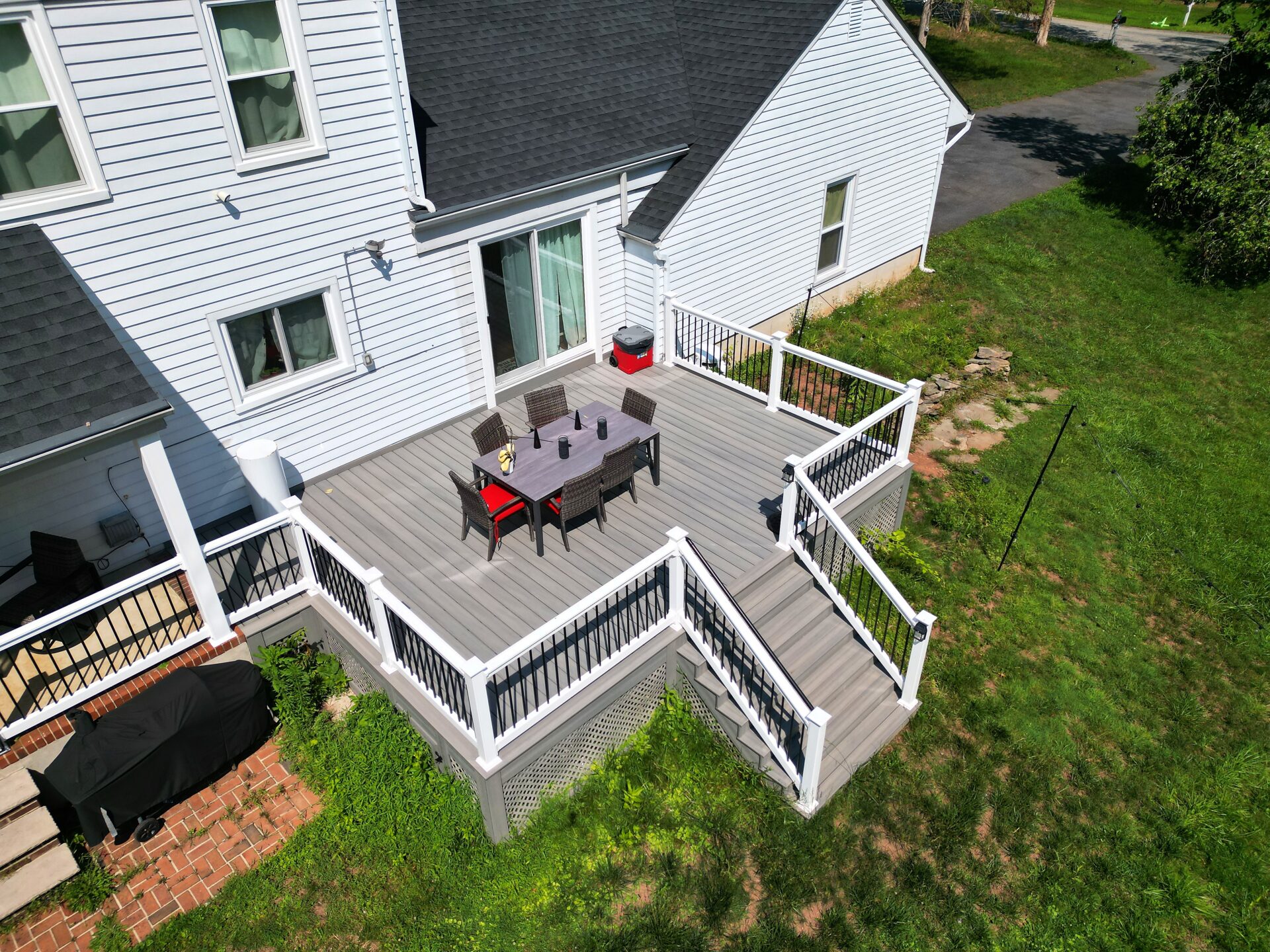 Aerial view of a resurfaced deck with Deckorators Venture Saltwater decking and white vinyl railing with black aluminum balusters in White House Station, NJ.