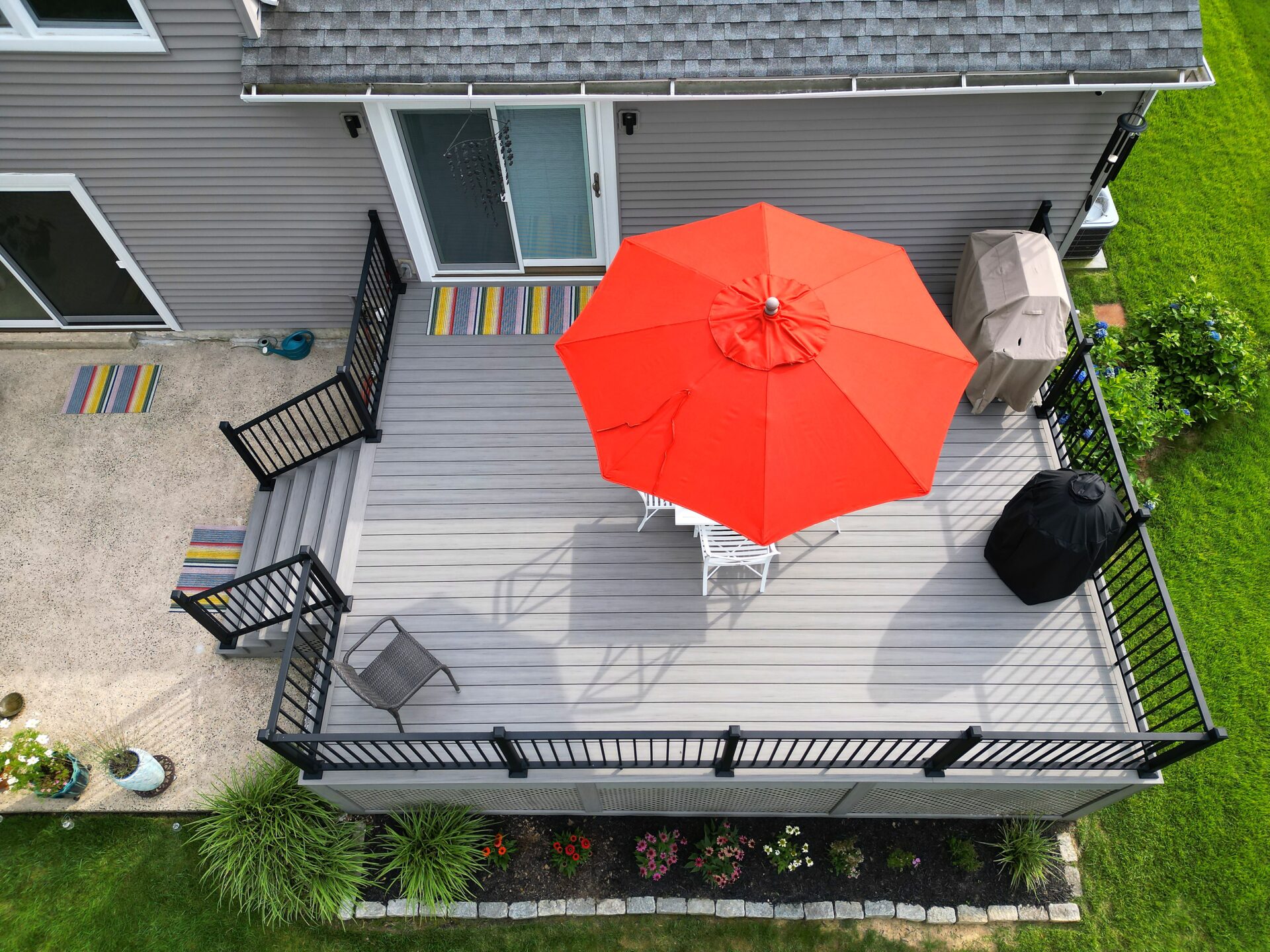 Aerial view of a resurfaced deck with Deckorators Venture Saltwater decking and white vinyl railing with black aluminum balusters in White House Station, NJ.
