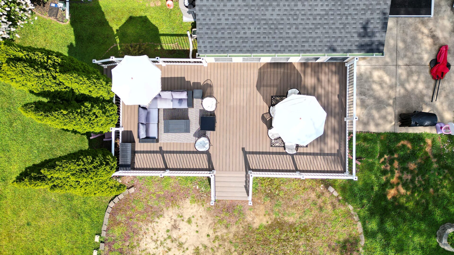 Overhead view of a resurfaced deck with Trex Enhance Honey Grove decking and white vinyl railing in Burlington, NJ.