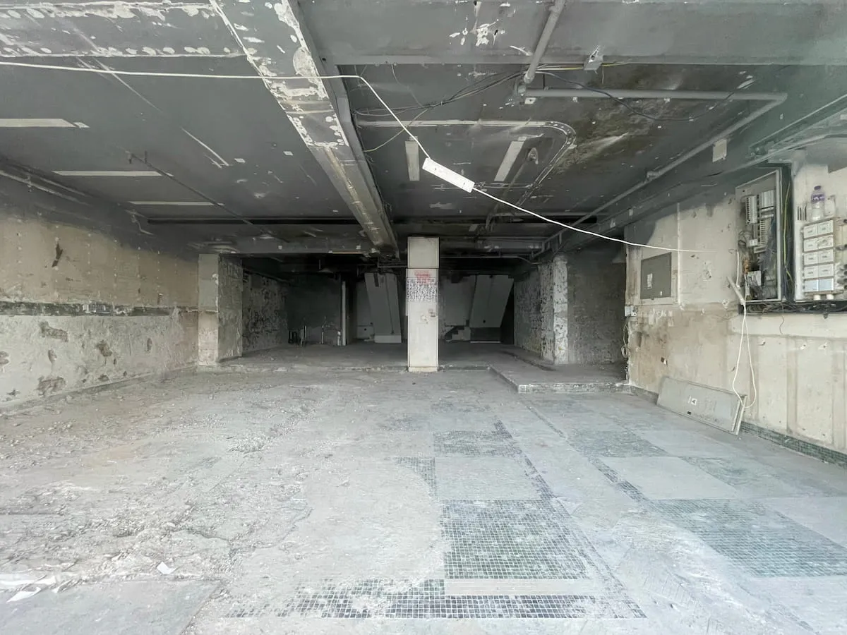 Ref#3608: An empty, unfinished room with exposed pipes, damaged walls, and a dusty concrete floor	68this space looks abandoned but offers great potential for office or shop rental.