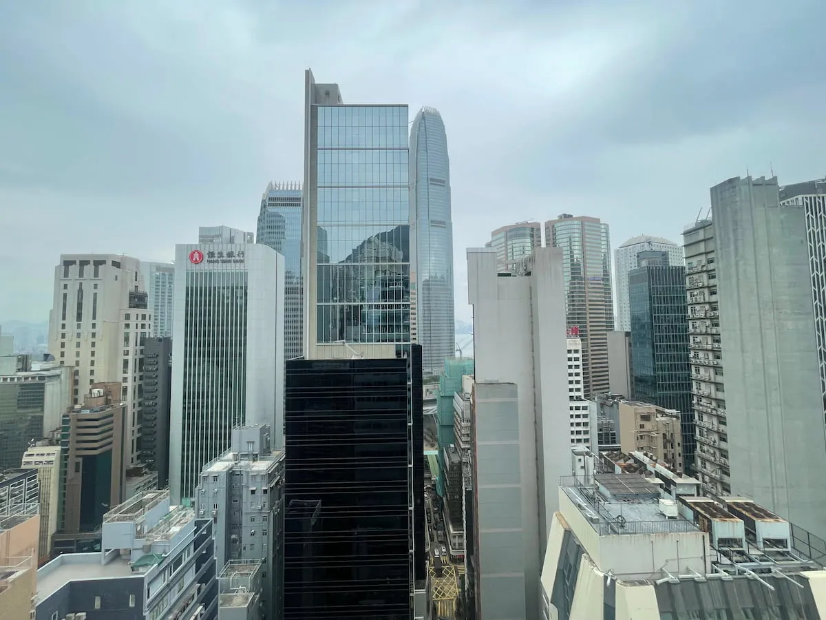 Ref#3616 offers prime office space for rent in an urban downtown area, featuring cityscape views of modern glass and concrete skyscrapers densely packed under a cloudy sky.