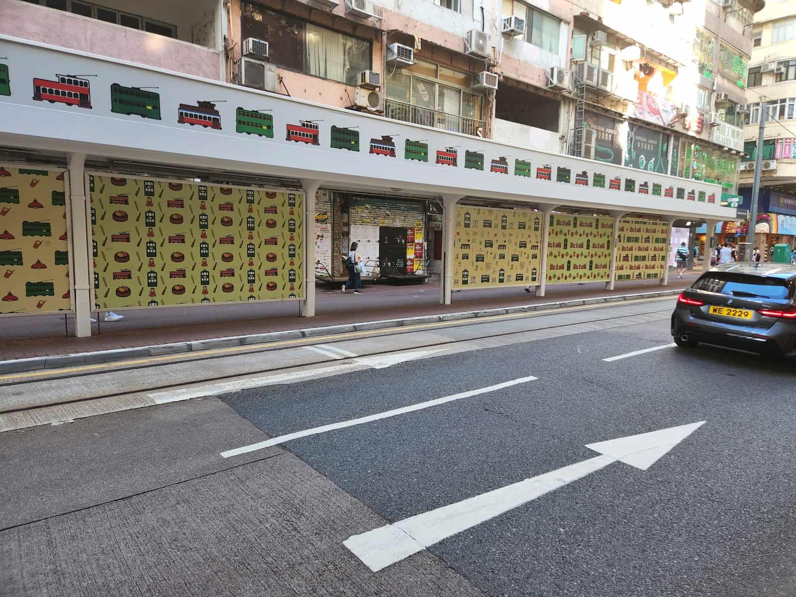 Ref#3578 features a city tram stop with illustrated walls by tracks, multi-story buildings with office or shop rentals nearby, plus a black car and road arrows.