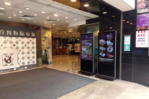 Ref#3162: Restaurant entrance with digital menu boards and a brightly lit interior. KFC signage is visible by the entrance, making this high-traffic location ideal for restaurant rental opportunities.