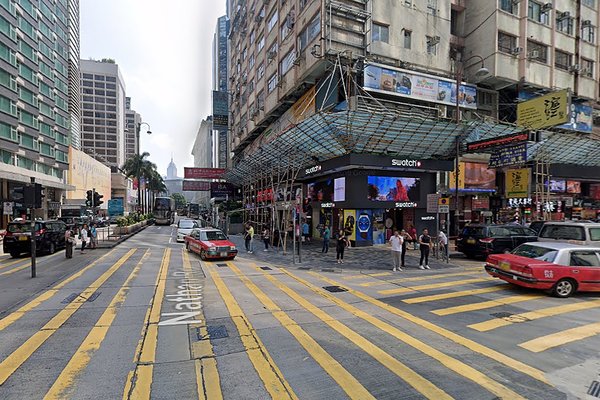At a bustling urban intersection with yellow crosswalks, tall buildings, shops, taxis, and billboards promoting office or shop rentals, Ref#3447 offers prime space in a lively city filled with pedestrians.