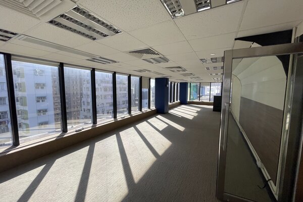 Ref#3275 features an empty office space with large windows filling the carpeted floor with sunlight, visible ceiling lights and vents, plus an open glass door—ideal for anyone looking to rent modern office space.