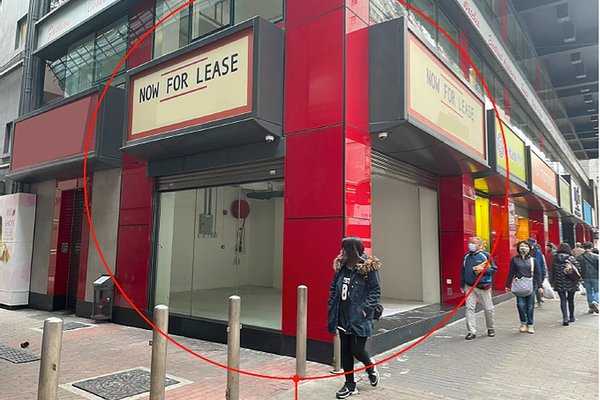 A woman walks past a red and black storefront labeled Ref#3524 with large NOW FOR LEASE signs. It's ideal for anyone looking to rent a shop or open a restaurant. Other pedestrians are nearby on the busy city street.