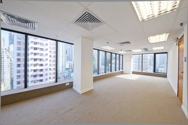 Ref#3369: Bright, empty office with large windows on two sides, beige carpet, white walls, overhead lights, and city building views

ideal office space for rent.