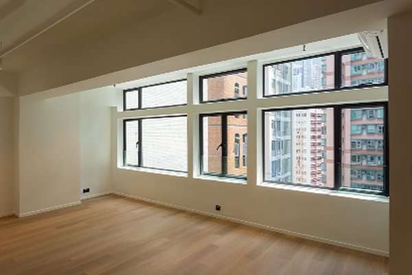 Ref#3201: Bright empty room with light wood floors and large windows overlooking city buildings95perfect for rent as an office or shop in a prime urban location.