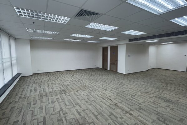 Office on Queen's Road West, Sheung Wan. Empty office on Queen’s Road West, Sheung Wan with beige carpet, white walls, drop ceiling and fluorescent lights.