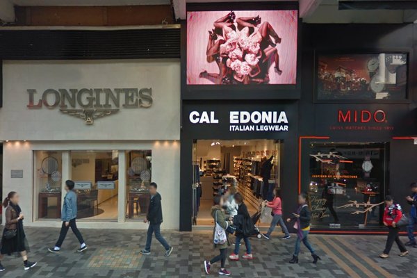 Ref#3376: Street view of several shops, including Longines on the left and Calzedonia Italian Legwear in the center. Great for shop rental with a large black and white advertisement above Calzedonia visible to passersby.