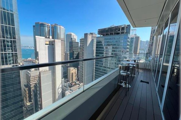 Ref#3316 features a high-rise balcony with glass railing and city skyline views, offering rentable office space complete with tables and chairs	68ideal for breaks or informal meetings under a clear blue sky.