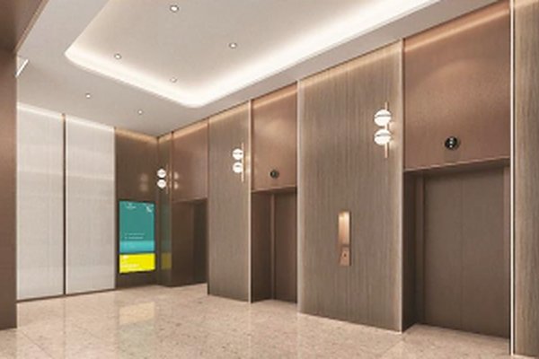 Ref#3507 features a modern elevator lobby with two closed elevator doors, wood-paneled walls, marble floors, wall lights, recessed lighting, and a digital directory perfect for renters seeking an upscale office space.