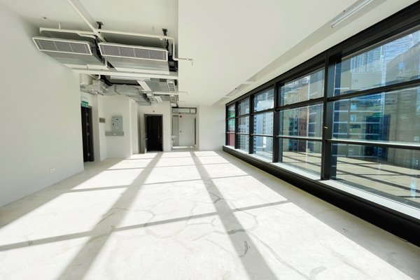 Ref#3192: Bright, empty office space for rent with floor-to-ceiling windows, white walls, exposed ceiling and air ducts, plus abundant sunlightideal for your next office or store.