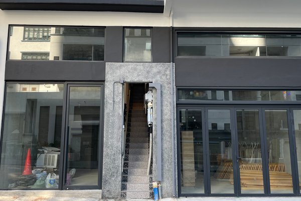 A narrow staircase with gray steps, identified as Ref#3420, sits between large glass windows. Items like a red traffic cone and wooden planks are visible inside, suggesting the potential to rent office or shop space above.