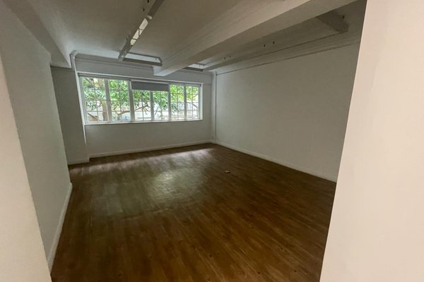 Ref#3455: Bright office space with white walls, wooden flooring, and large windows offering natural light and views of treesperfect for rent.