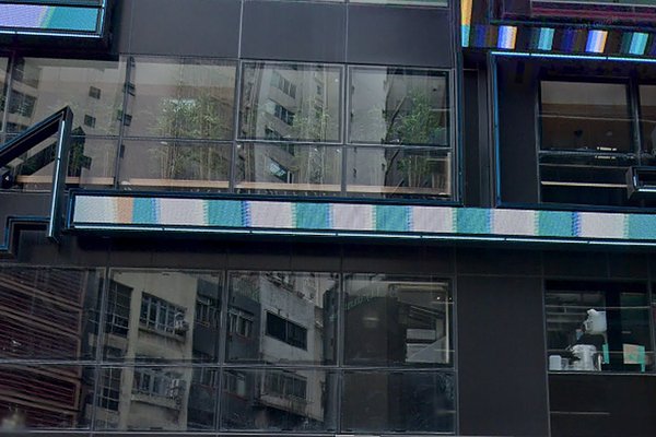 Ref#3545: Modern black building with reflective glass windows mirrors nearby apartments; subtle interior plants and decor suggest an ideal office or shop rental in a prime location.