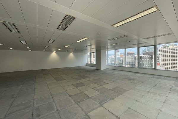 Ref#3422: Unfurnished office space featuring tiled floors, white walls, grid ceiling lights, and large windows offering city views and natural lightideal for renting in a prime location.