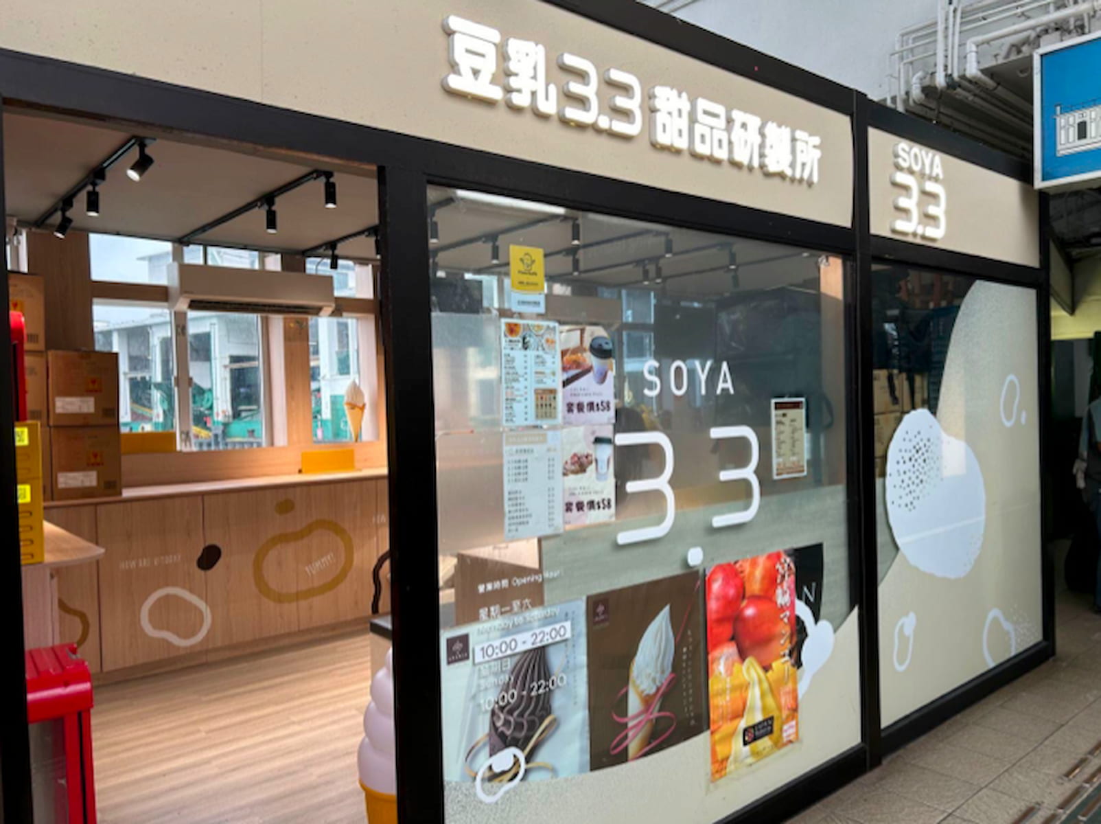A modern storefront for "Ref#3019" offering soy-based desserts and drinks, ideal for shop or restaurant rentals. Features large windows with menu posters, bright bilingual signage, and a light wooden interior.