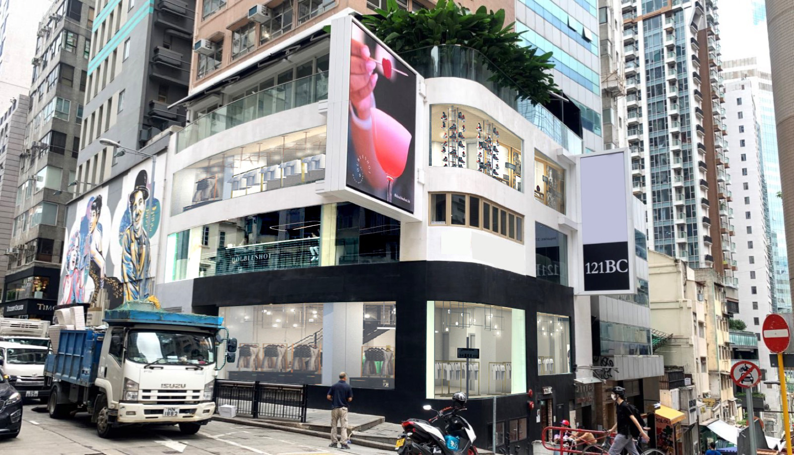Ref#2980 is a modern glass-fronted building on a lively city corner, with large digital billboards and parking nearby. Perfect for those looking to rent office or lease shop space amid vibrant urban surroundings.