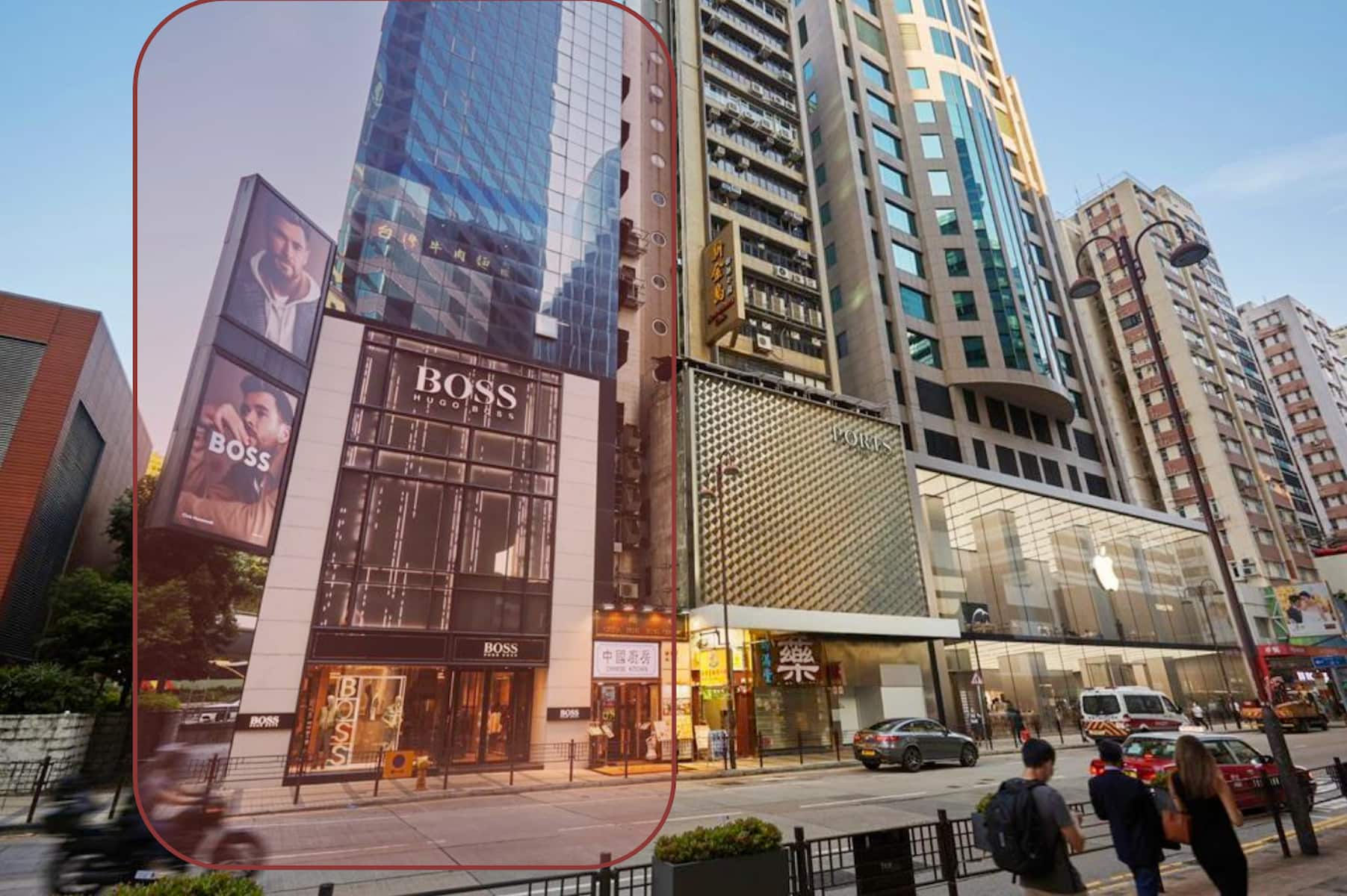 Ref#3120: Prime city street location featuring tall modern buildings, a Hugo Boss store with fashion ads, and an Apple store. Pedestrian and car traffic make it perfect to rent as shop or office space in daylight.