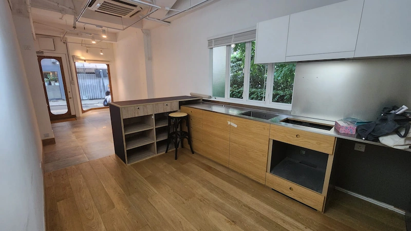 Restaurant space on Second Street, Sai Ying Pun. Kitchen with wood floors, open shelves, window, and glass door opening to Second Street.