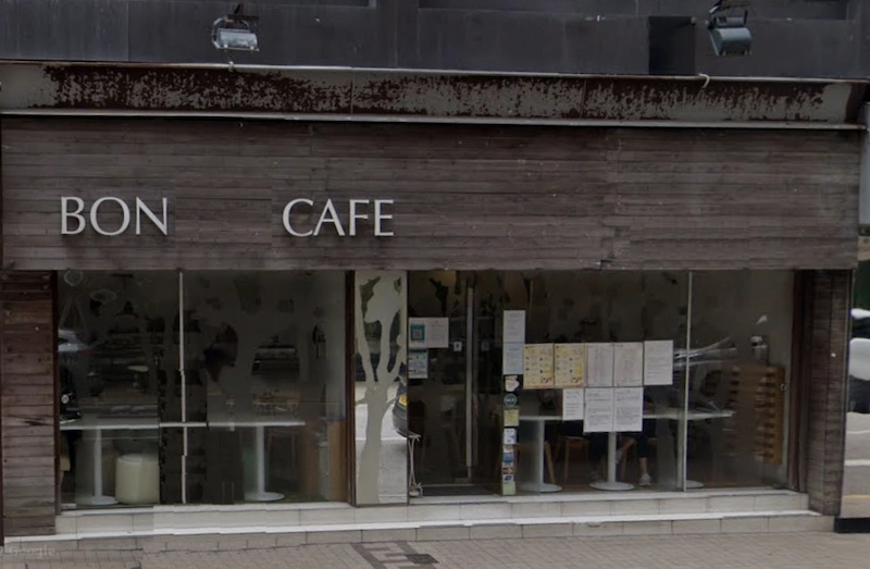 Restaurant space on Leighton Road, Causeway Bay. Bon Cafe storefront with large glass windows, wooden exterior, and menus displayed outside.
