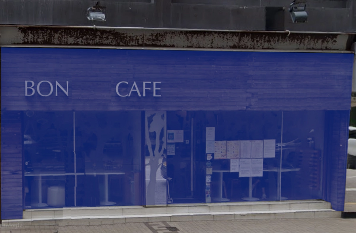 Cafe with blue exterior and large glass windows on Leighton Road, BON CAFE sign displayed on the front.
