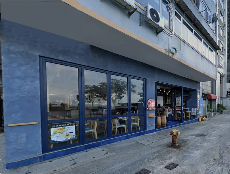 Restaurant space on New Praya, Kennedy Town. Blue-painted restaurant with large windows, visible indoor tables, and fire hydrant.