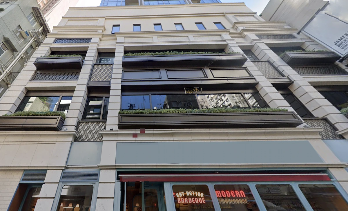 A multi-story building with balconies and ground floor shops on Staunton Street in Central, seen from street level.
