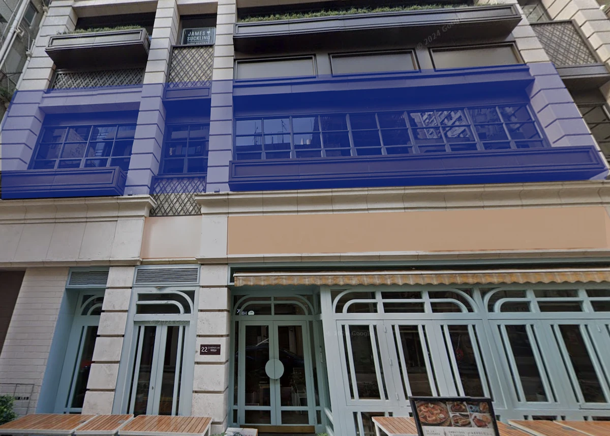 Staunton Street in Central with a building featuring blue windows and outdoor seating visible at the front.