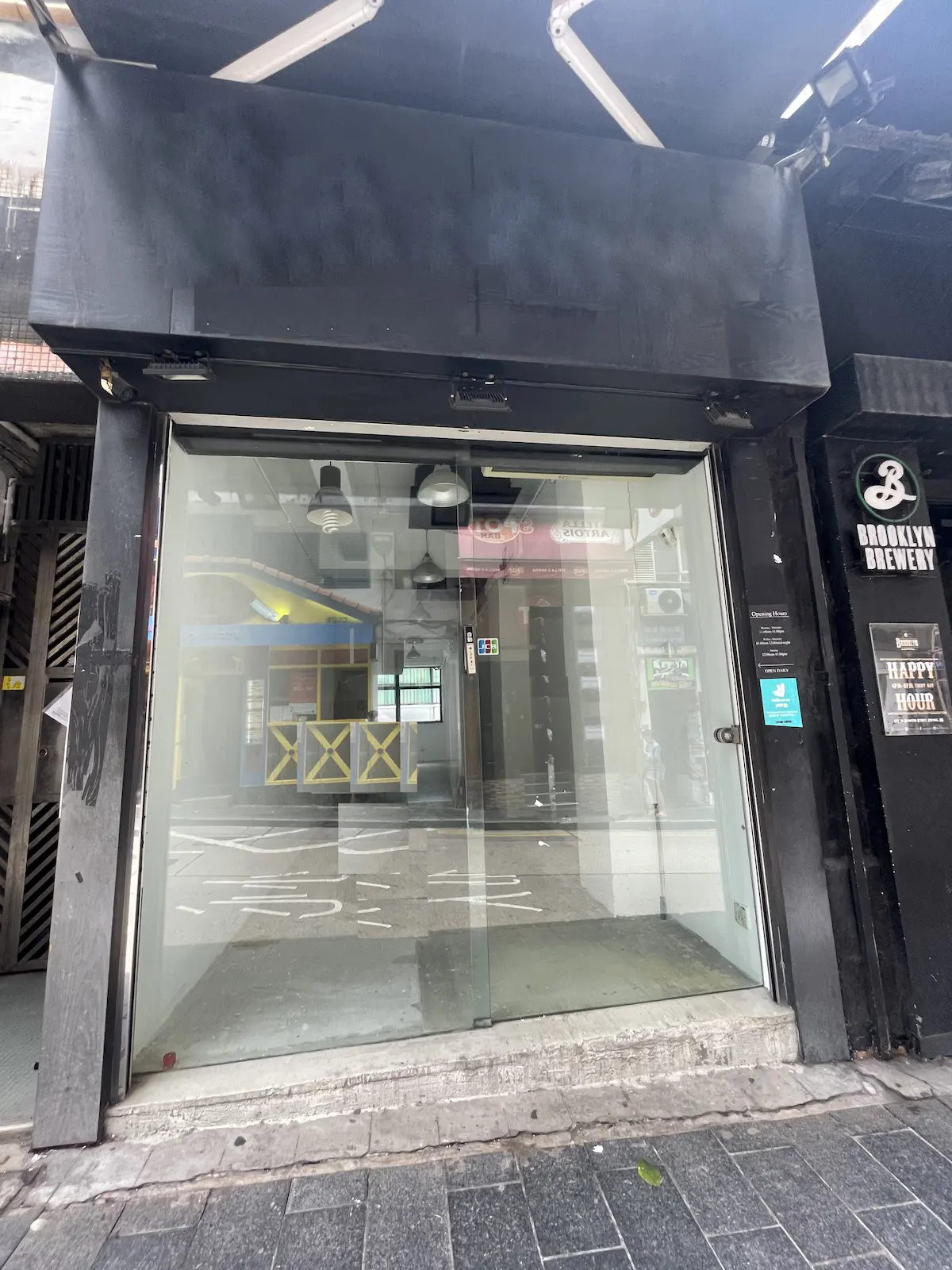 Empty storefront with glass doors on Staunton Street and a Brooklyn Brewery sign visible on the right side.