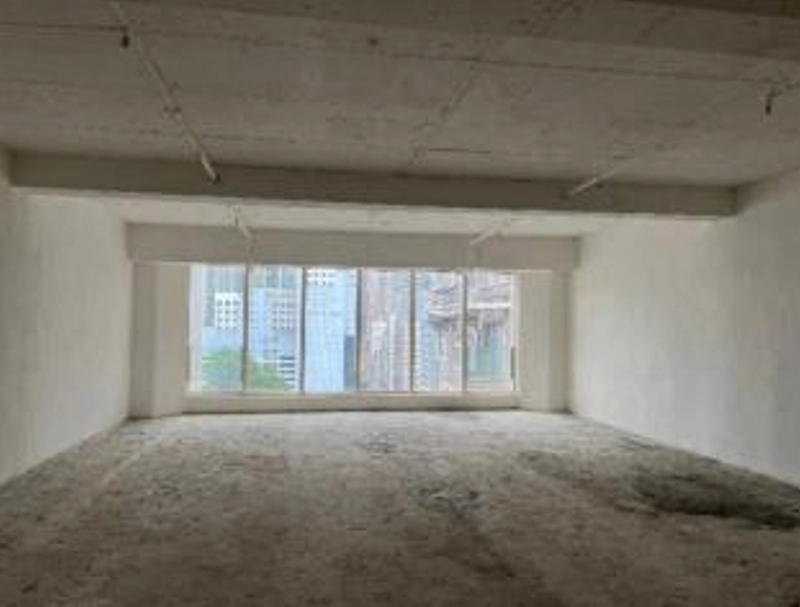 Shop on Nathan Road, Tsim Sha Tsui. White-walled minimalist room with large windows and concrete floor similar to spaces on Tsim Sha Tsui’s Nathan Road.